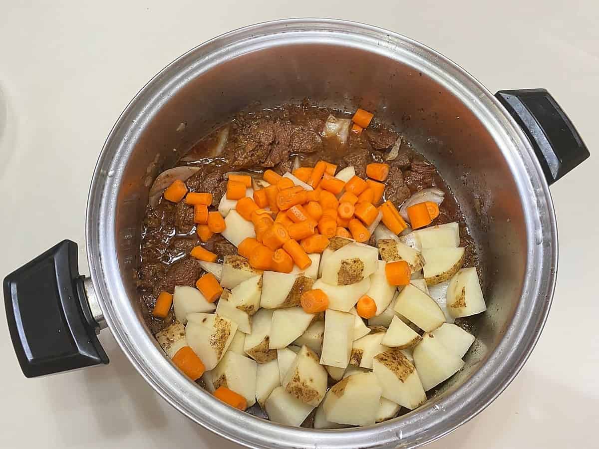 Add Potatoes and Carrots to the Meat after it has Simmered