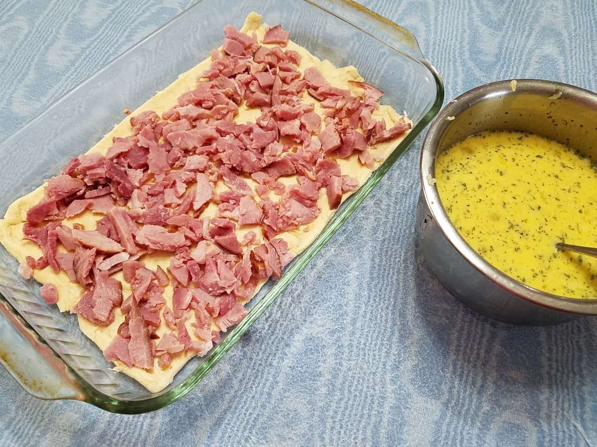 Preparing the Casserole with Chopped Ham and Egg Mixture