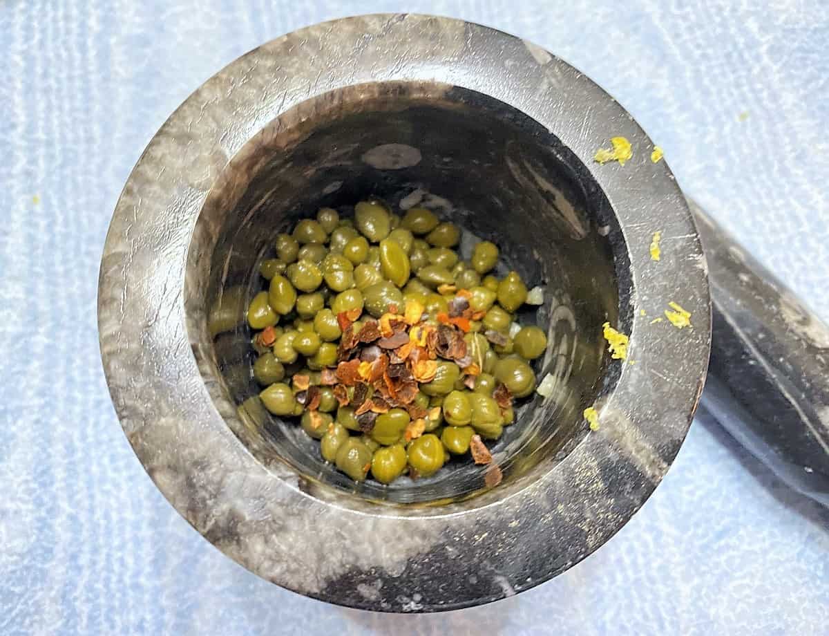 Mashing Capers in Mortar and Pestle