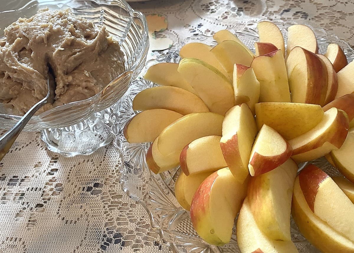 Serving Sliced Apples and Peanut Dip at a Tea Party