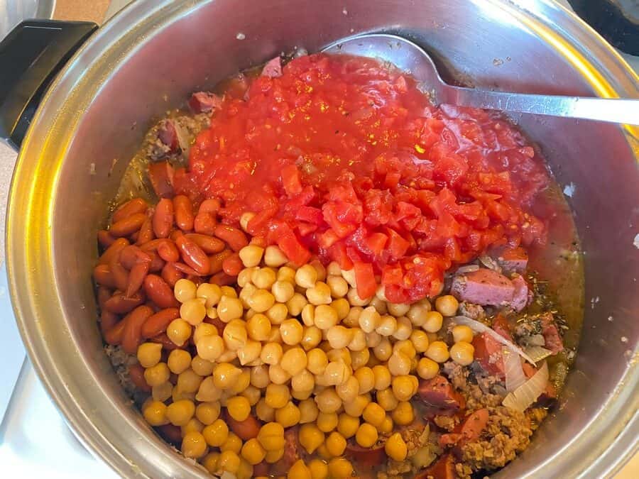Adding Beans, Tomatoes, Herbs, and Seasonings to the Soup