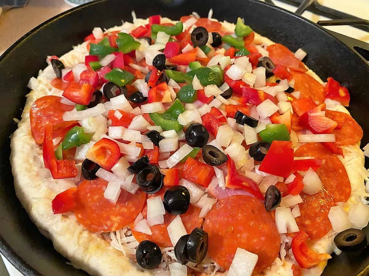 Top Pizza Dough with Desired Meats and Vegetables
