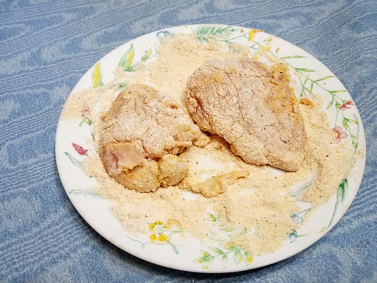 Dredging Chicken in Seasoned Flour Mixture