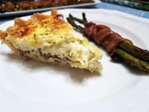 Serving Breakfast Quiche with Bacon Wrapped Asparagus