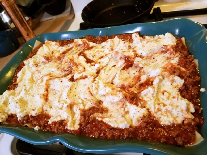 Assembling Homemade Lasagna in Dish