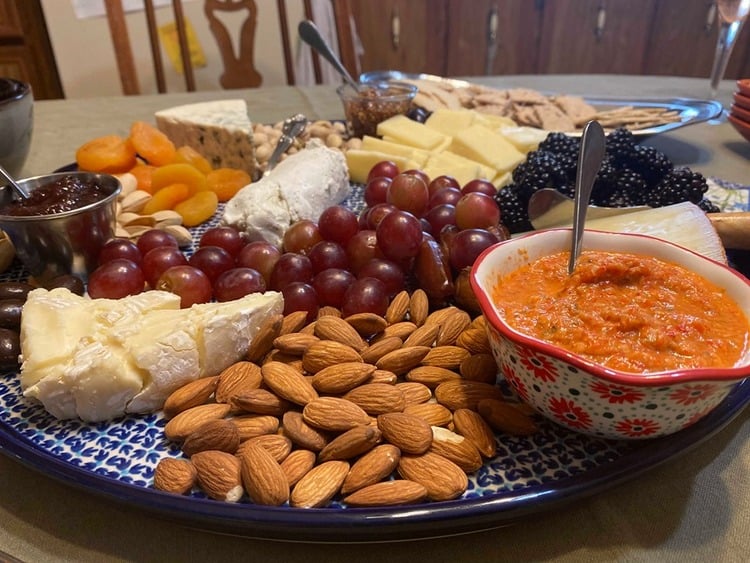 Charcuterie board with roasted red pepper tapenade