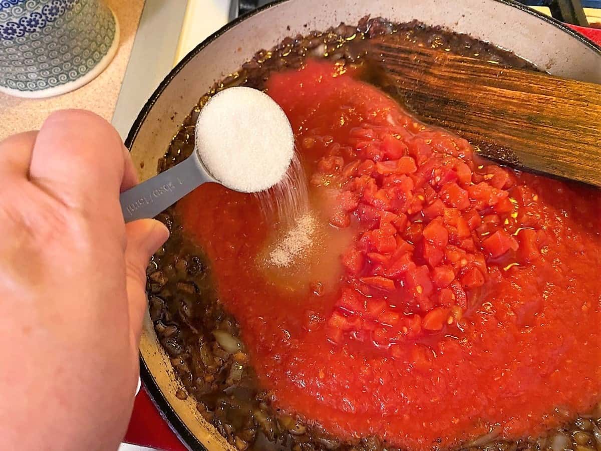 Add Tomatoes, Sugar, and Herbs to the Red Sauce