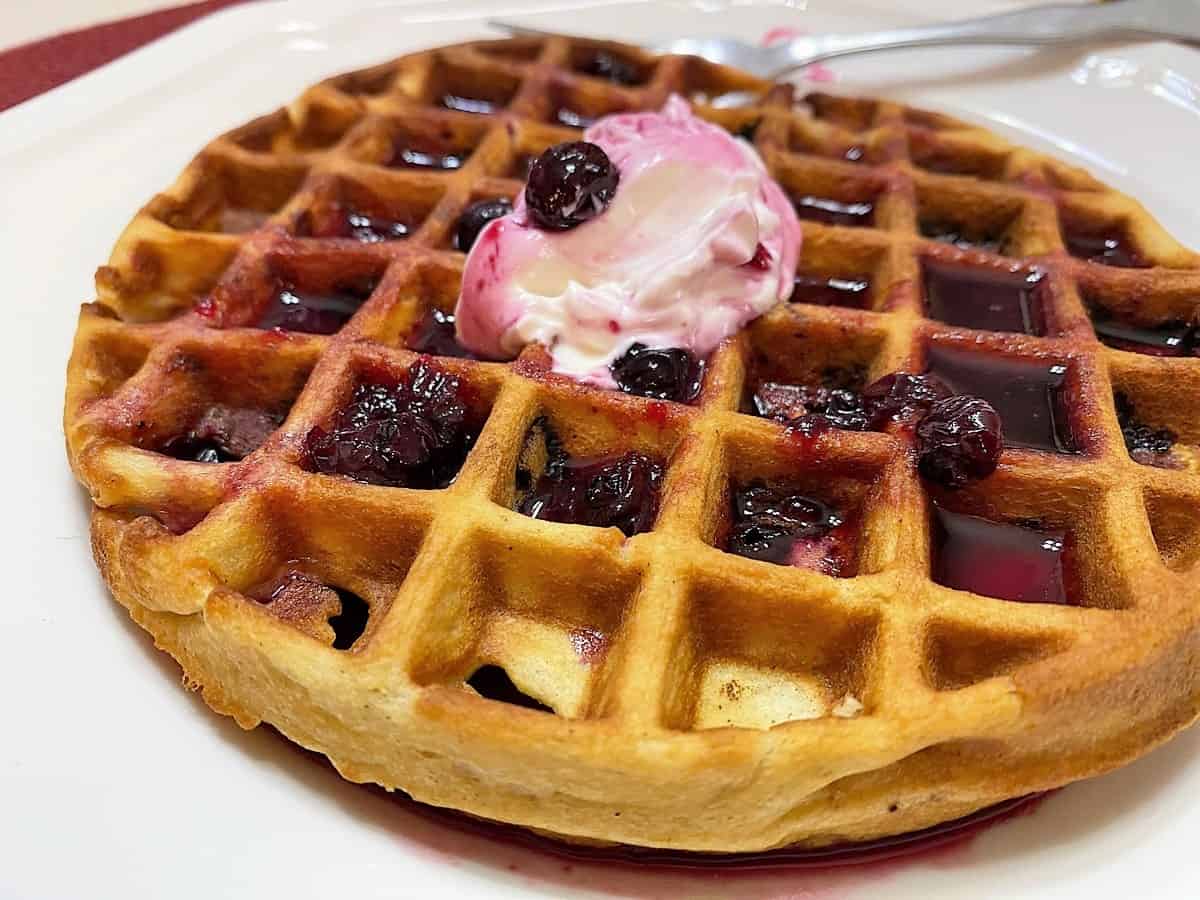 Serve Blueberry Eggnog Waffles with Sour Cream and Blueberry Syrup