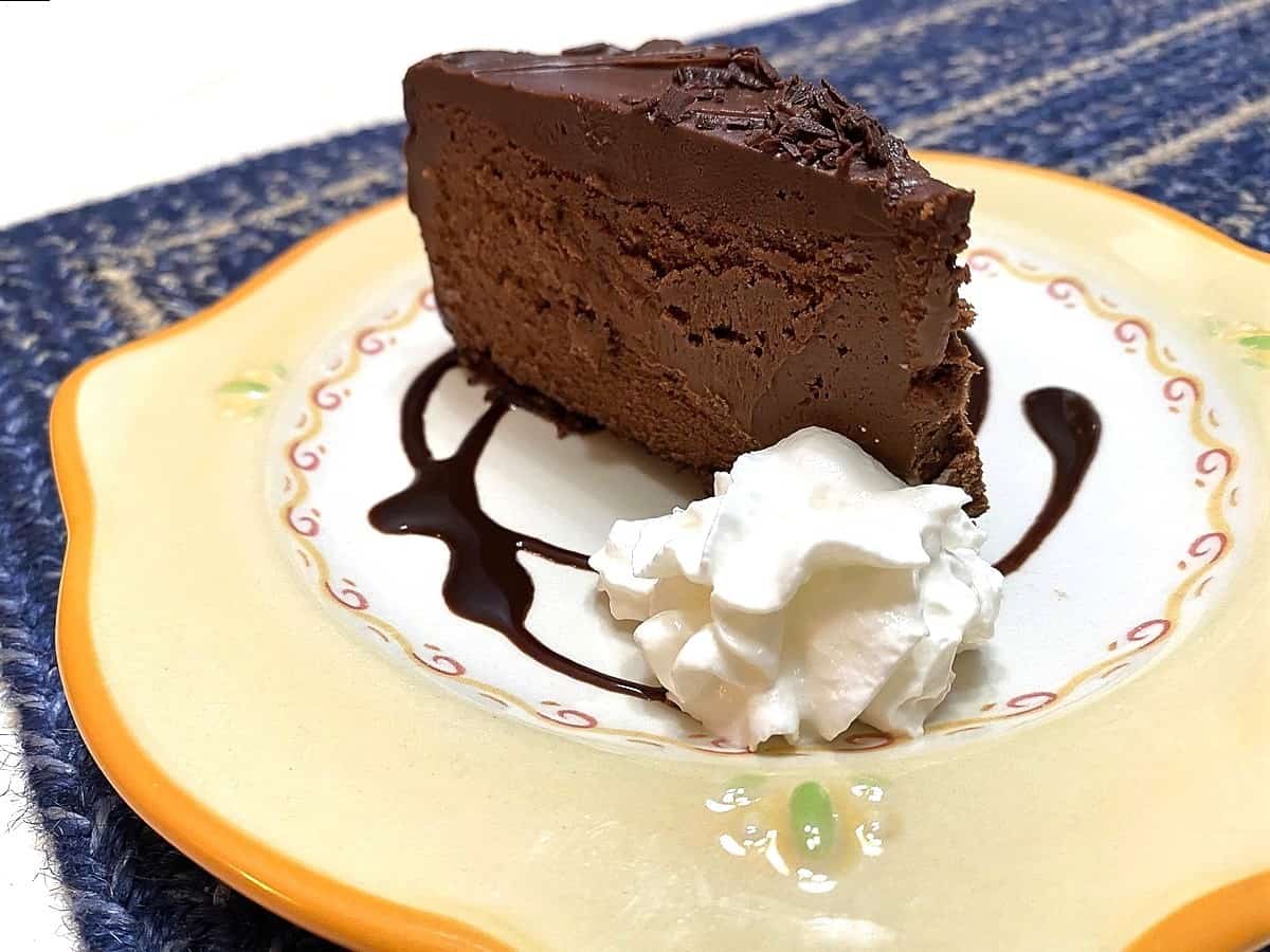 Serve Chocolate Fudge Truffle Cheesecake on Pretty Plates with Chocolate Swirl Garnish and Whipped Cream