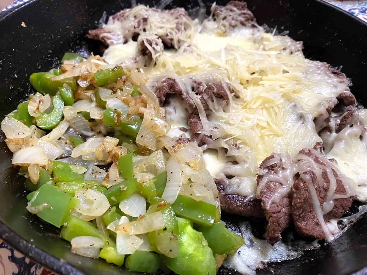 Cover Seared Steak with Grated Cheeses to Melt