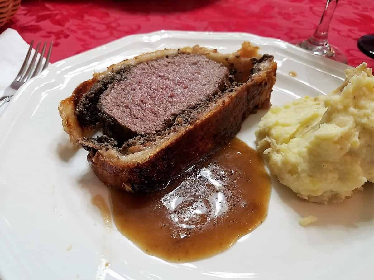 Serve Sliced Elk Wellington with Mashed Potatoes and Madeira Sauce