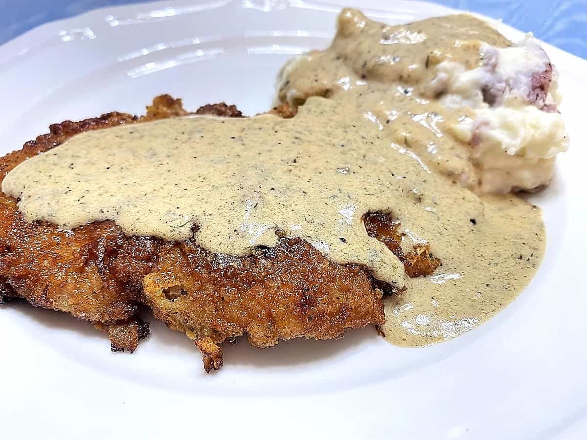 Serving Pork Schnitzel with Cream Sauce with Mashed Potatoes