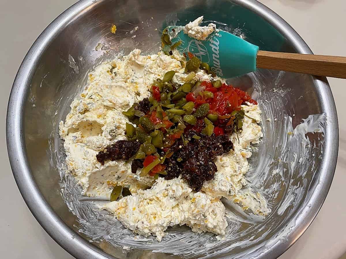Add Chopped Cornichons, Roasted Red Peppers and Sundried Tomatoes to the Cheese