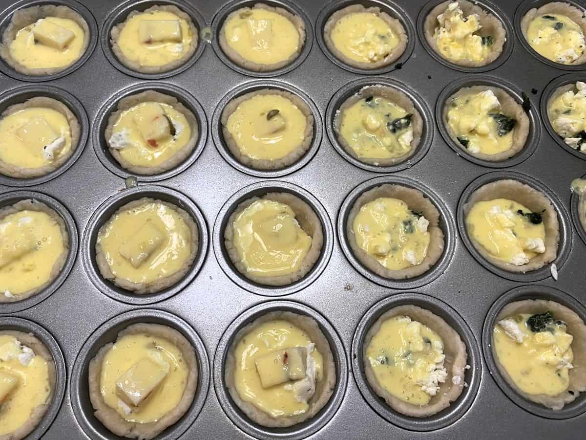 Spoon Egg Mixture into Cups over the Cheese and Spinach
